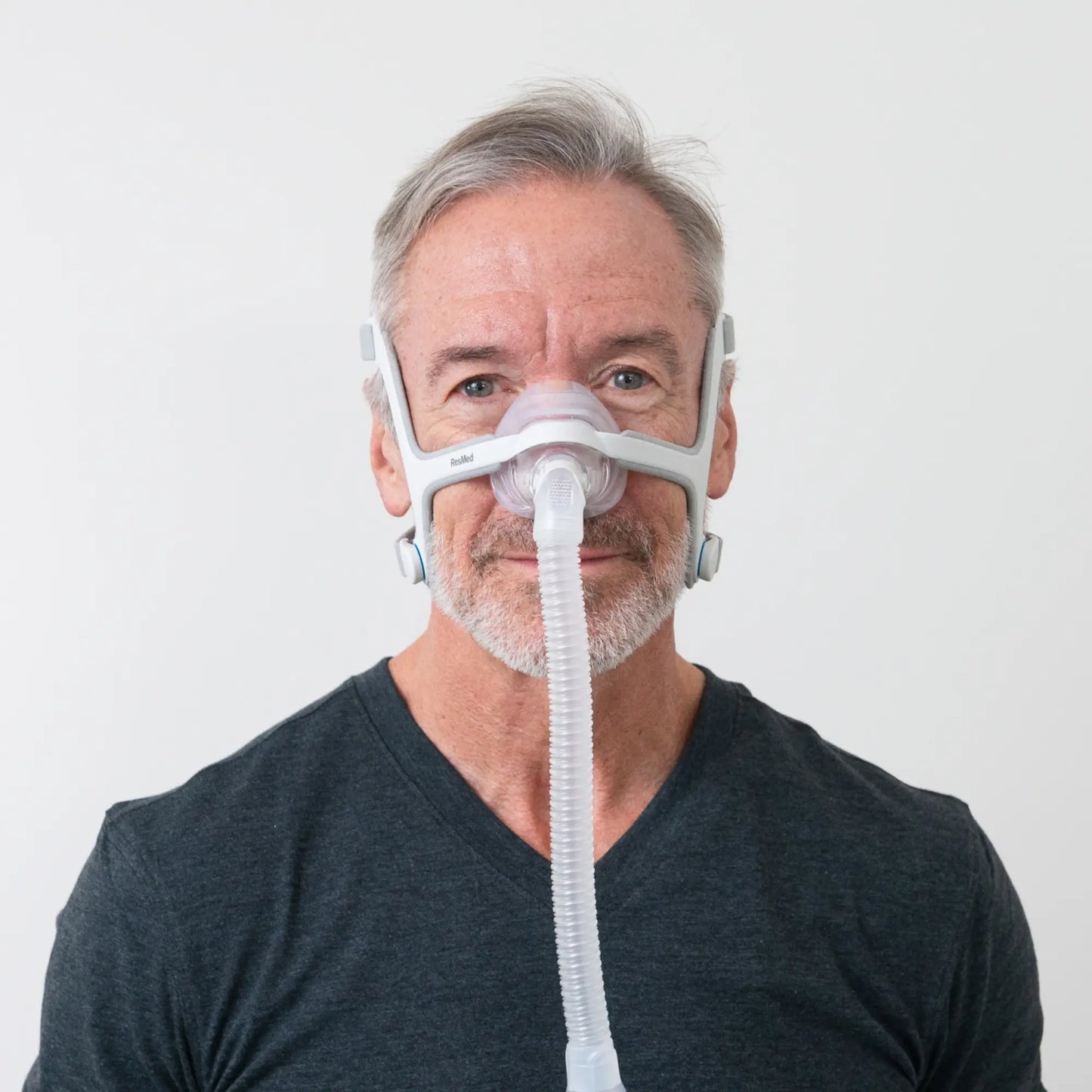 https://cdn.shopify.com/s/files/1/0318/9771/4819/files/man-using-the-resmed-airfit-n20-nasal-cpap-mask-with-headgear-front-view.webp?v=1745263236