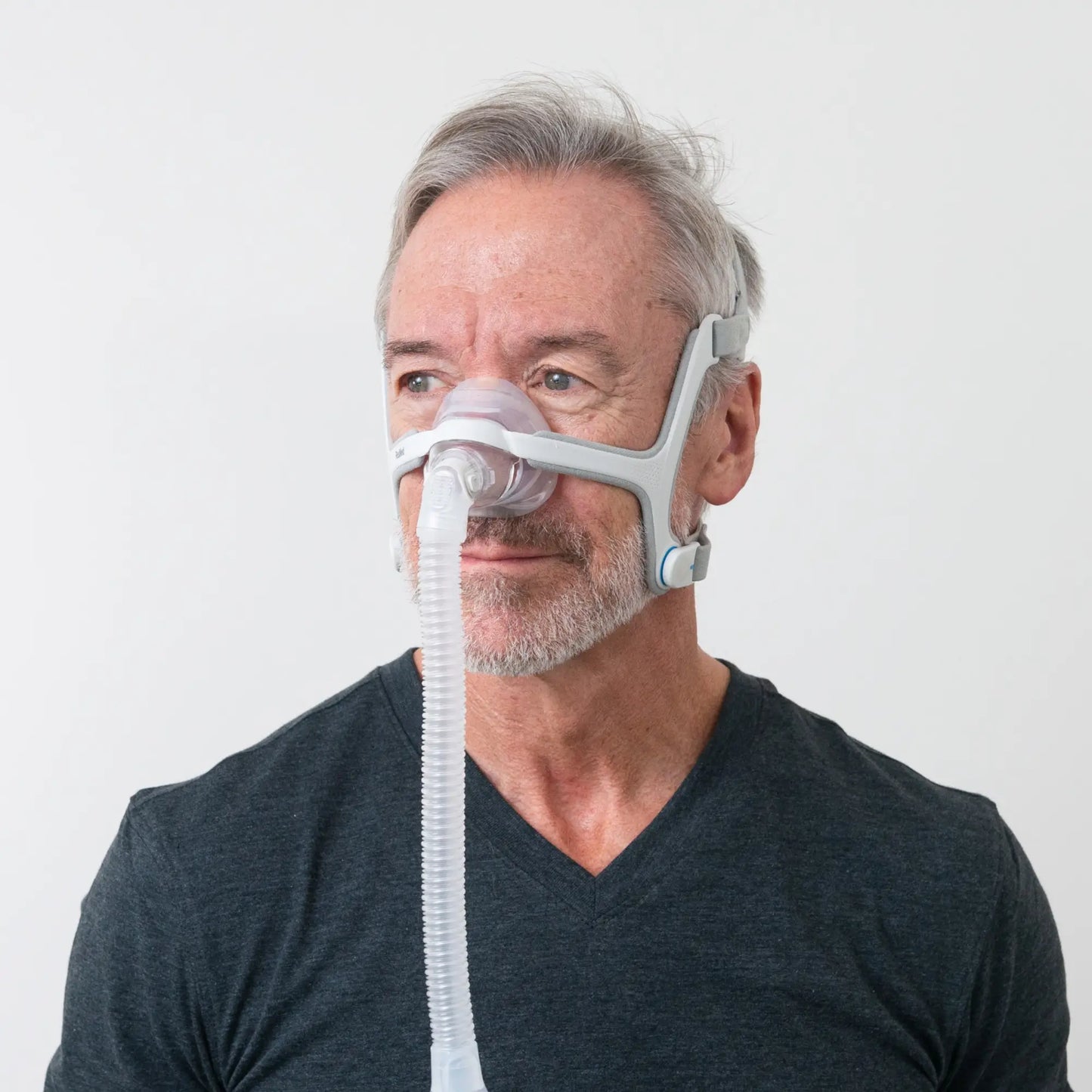 https://cdn.shopify.com/s/files/1/0318/9771/4819/files/man-using-the-resmed-airfit-n20-nasal-cpap-mask-with-headgear-side-view.webp?v=1745263236