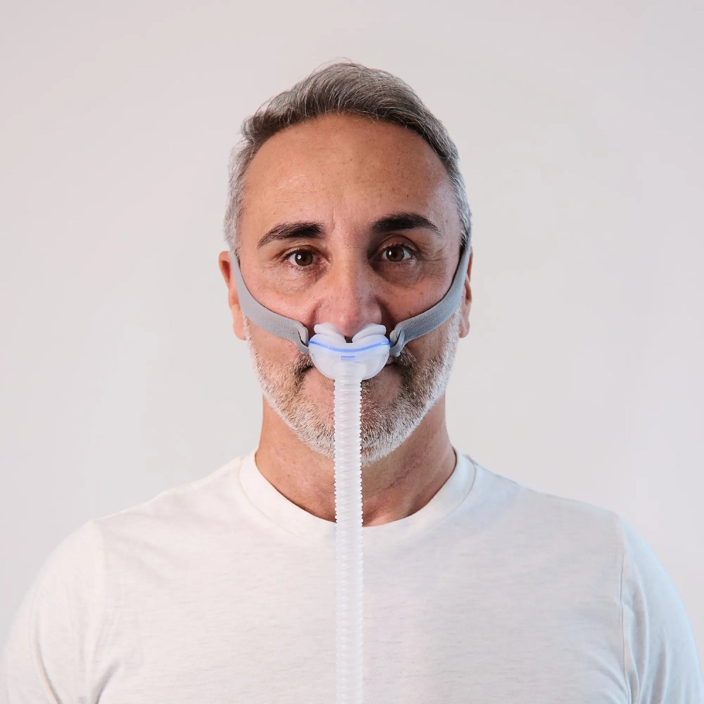 https://cdn.shopify.com/s/files/1/0318/9771/4819/files/man-using-the-resmed-airfit-p10-nasal-cpap-mask-front-view.webp?v=1745261538